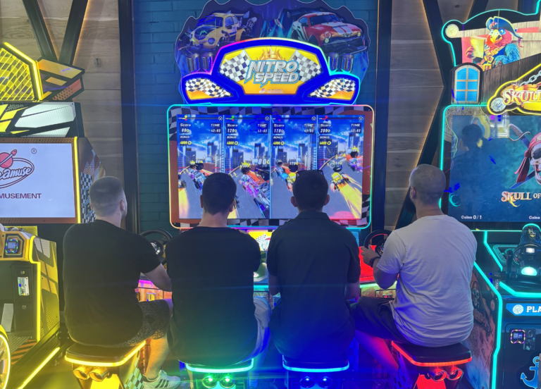 Mobile game development team playing arcade